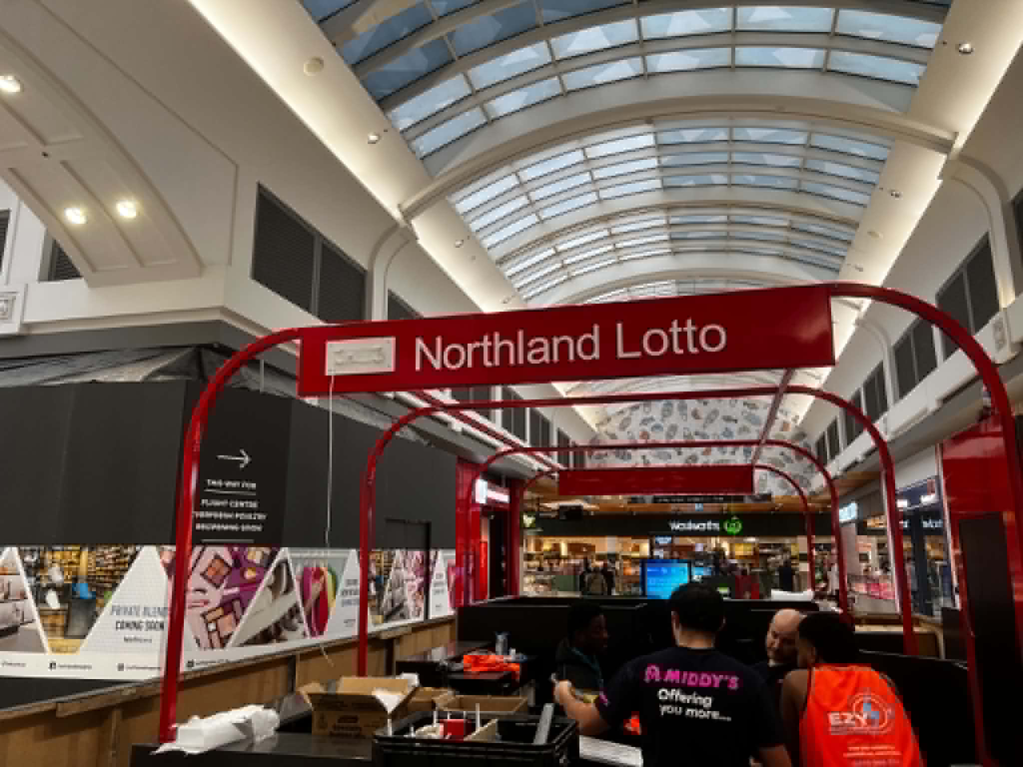 Curved steel frame and Northland Lotto sign above the kiosk counter