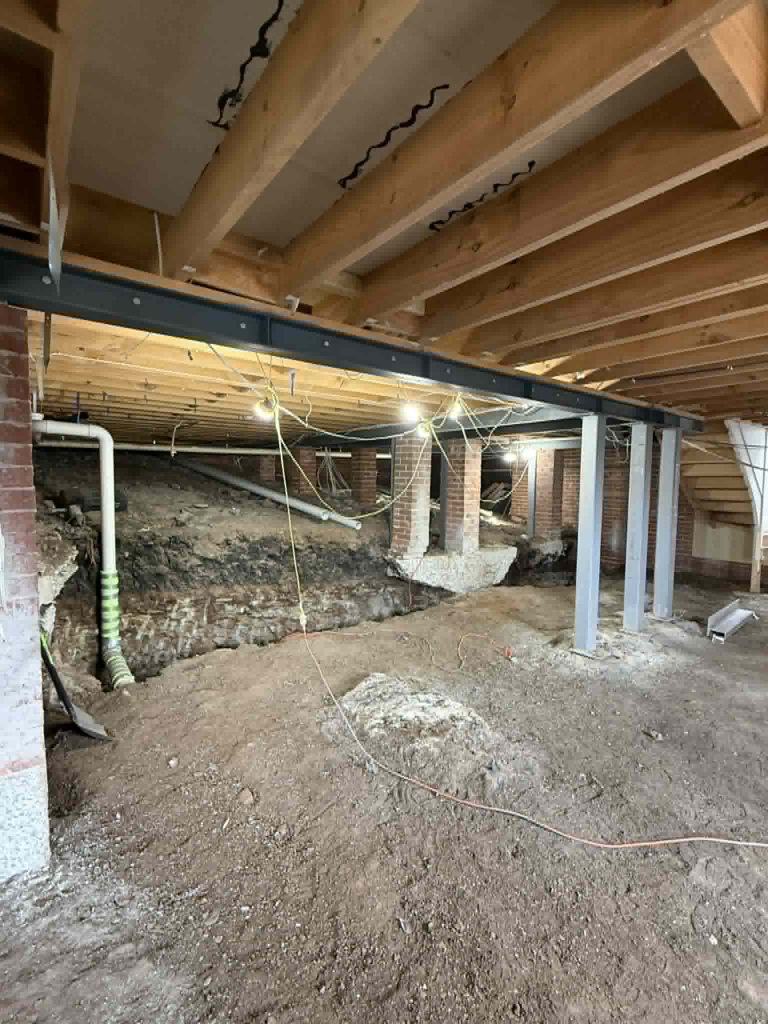 Steel support columns beneath timber floor joists at Avondale Heights