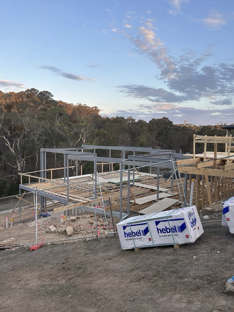 Wide view of steel framing and construction equipment at Diamond Creek