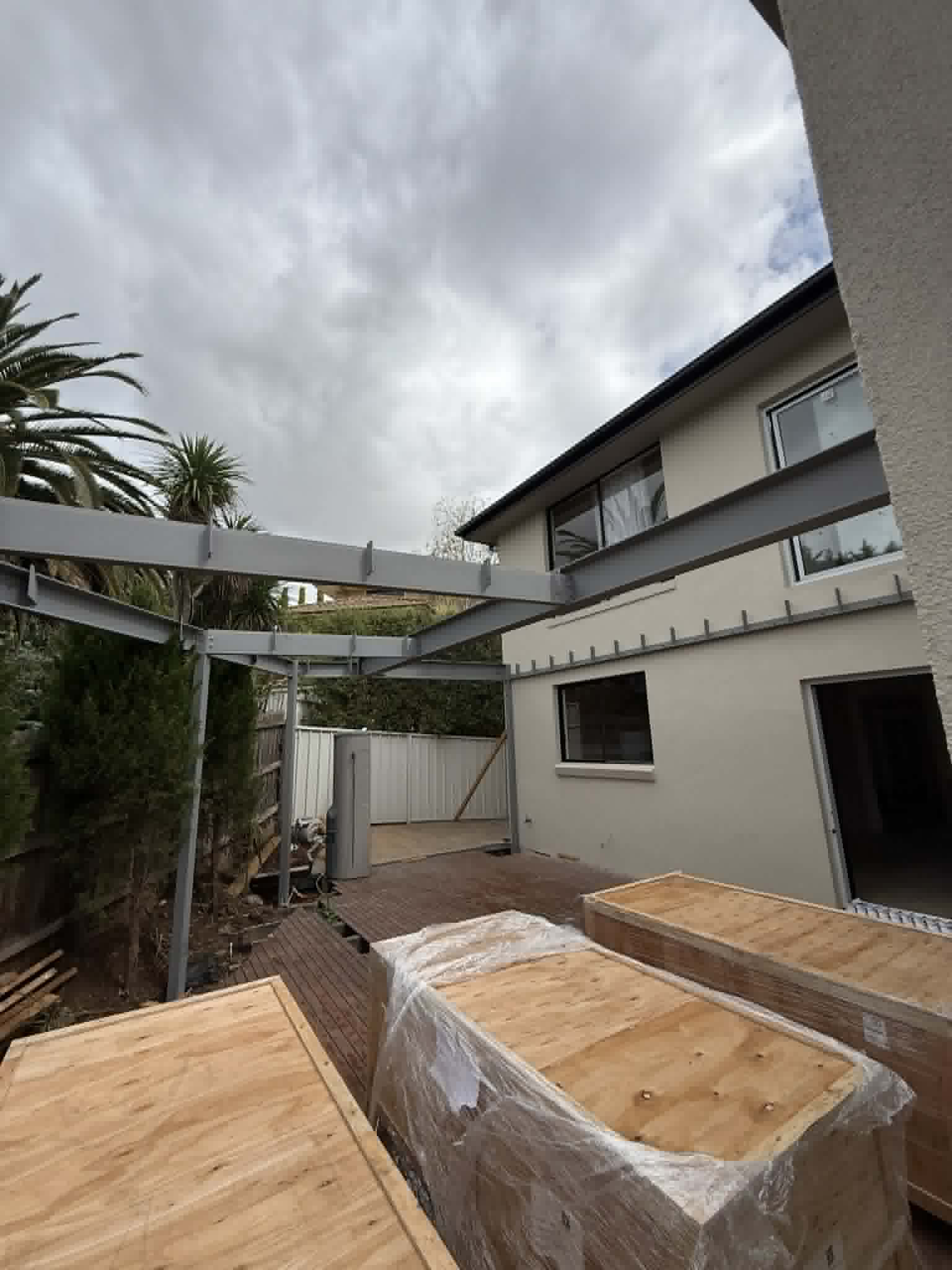 Steel framing above an outdoor deck beside a house at Avondale Heights