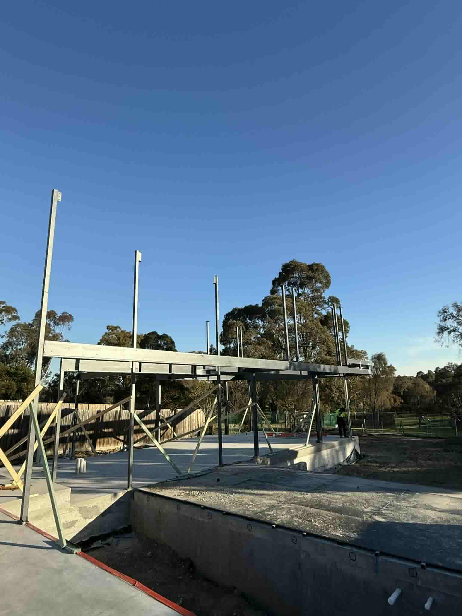 Side view of a steel beam supported above the Ivanhoe construction site