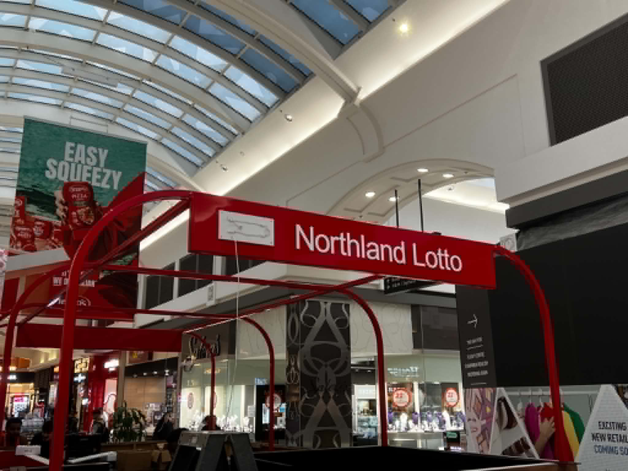 Northland Lotto sign mounted on curved red steel framing