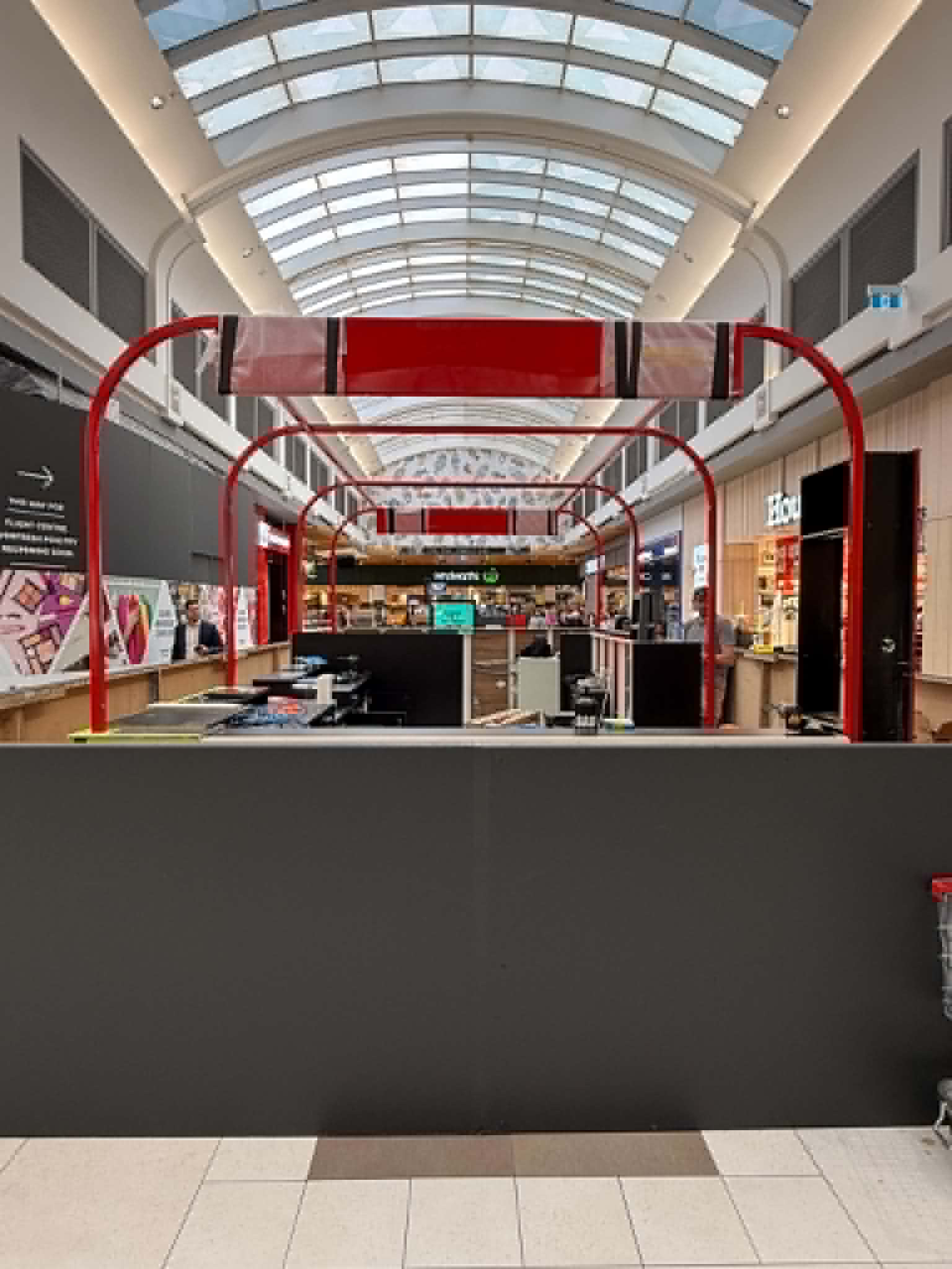 Front view of curved red steel framing above the Northland Lotto counter
