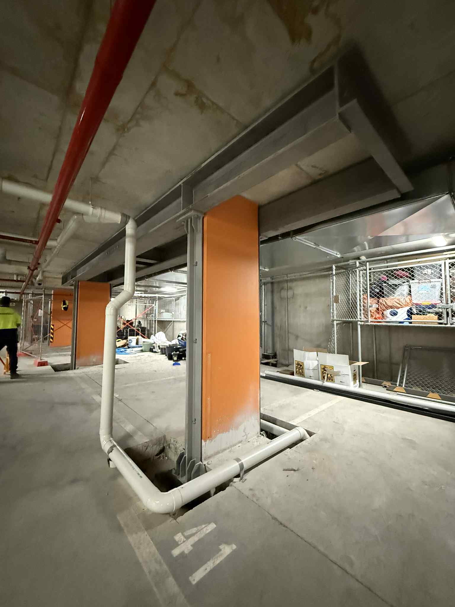 Steel support column fixed beside an orange pier at Glen Waverley