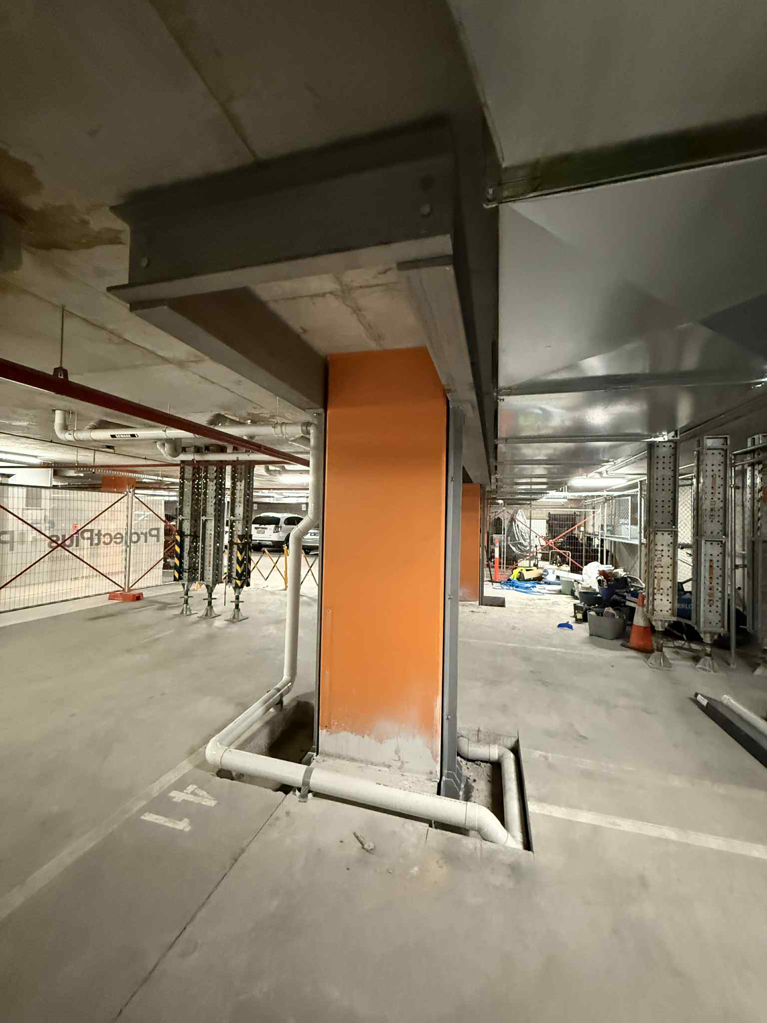 Steel column and overhead beam beside an orange pier at Glen Waverley
