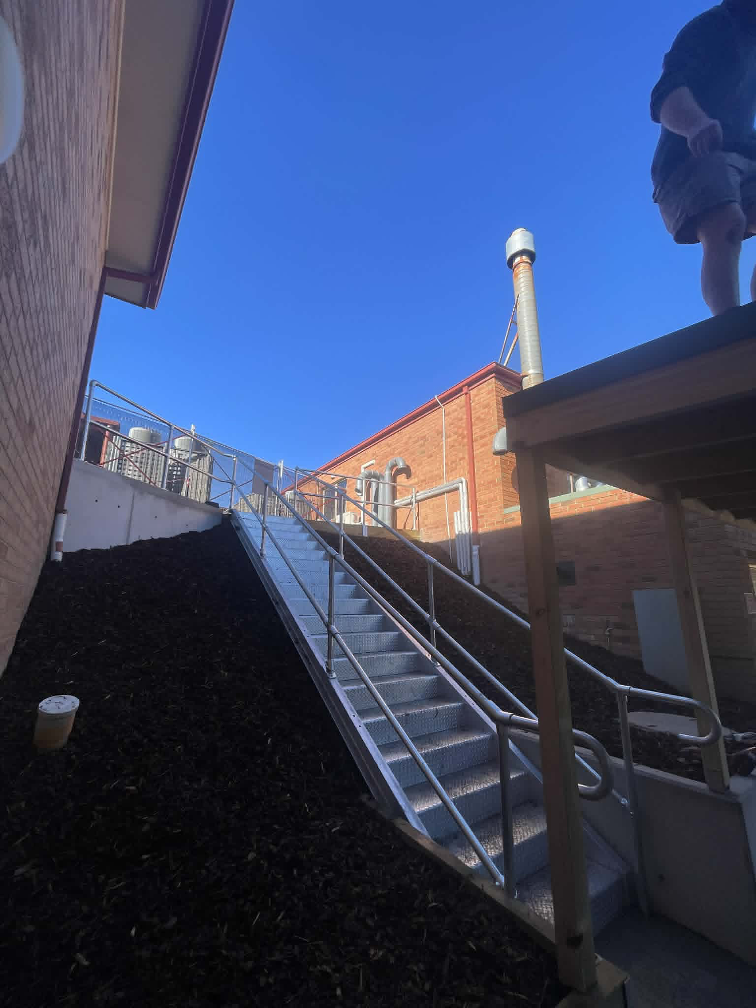 Steel ramp and handrails leading uphill beside a building at Kalimna