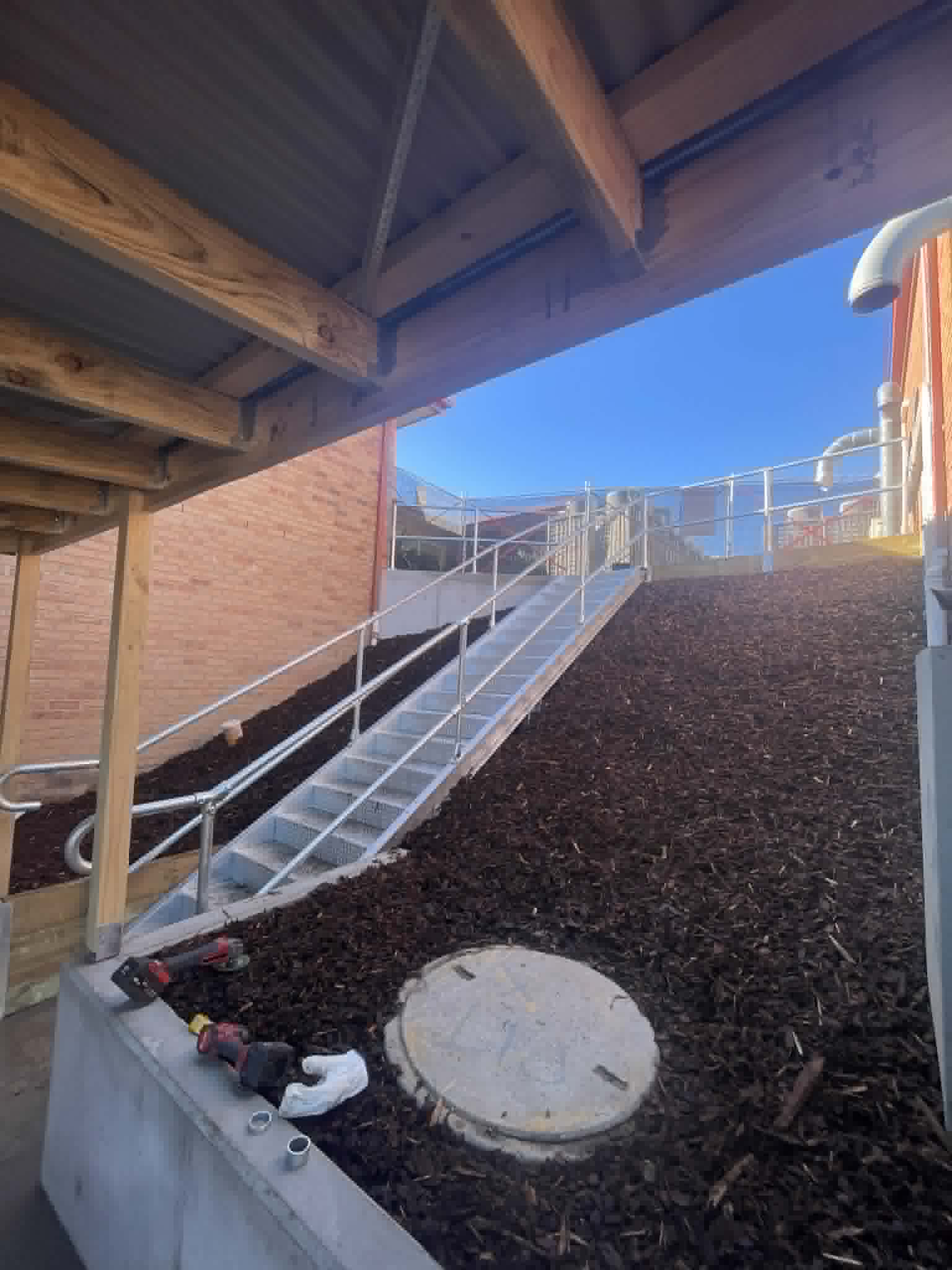Steel access ramp and handrails viewed from beneath a roof at Kalimna